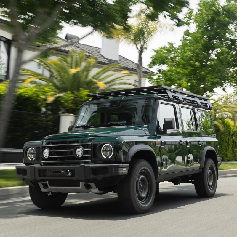 Green INEOS Grenadier on a residential road — UK manufacturer website photograph used for illustration